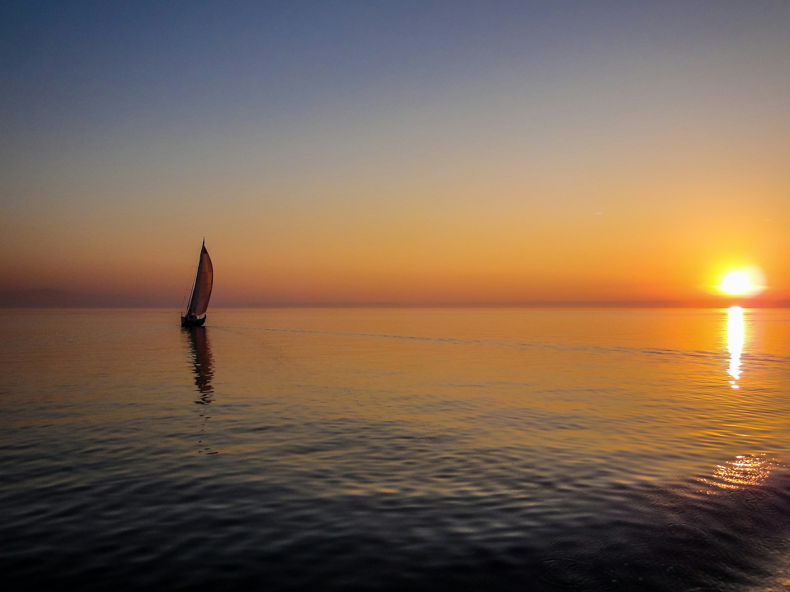 Photo by Fab Lentz silhouette of sail boat on body of water